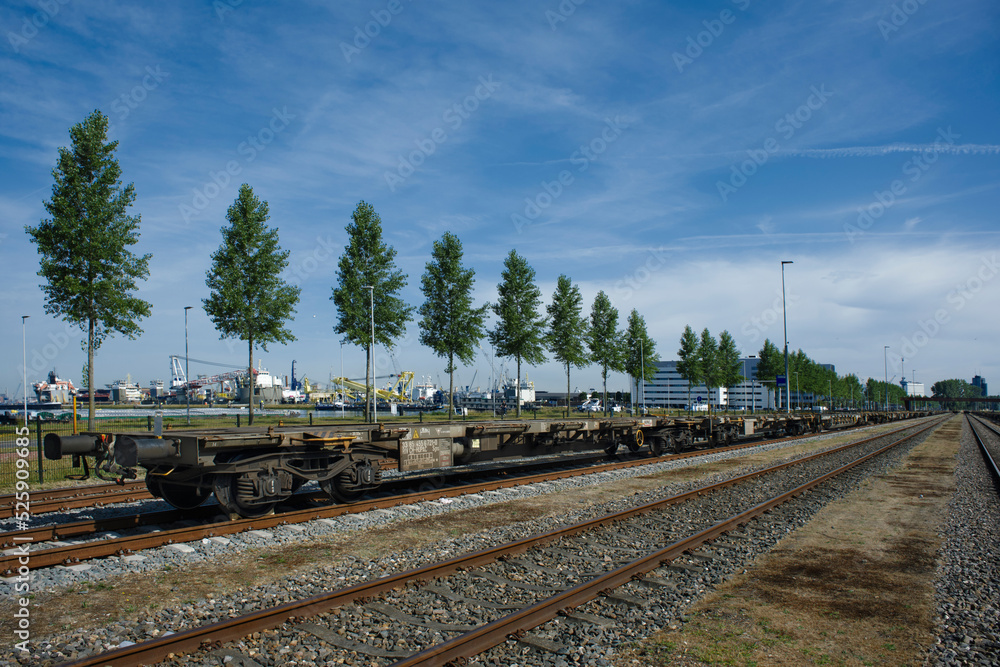 Fototapeta premium Rotterdam, The Netherlands. Low angle view of long line of freight trains on tracks in the port of rotterdam