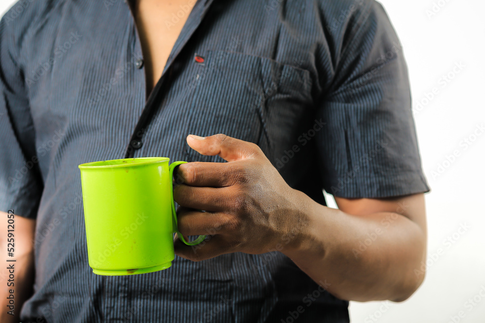 Close up man holding green mug Close up man holding green mug