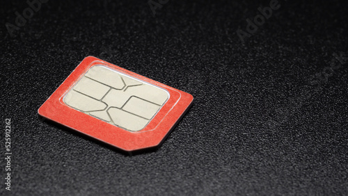 red sim card for 4G,  gsm mobile phone on black background photo