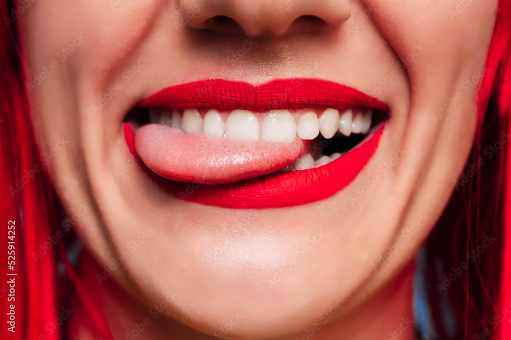 Sexy female lips. Funny open mouth with tongue sticking out. A smiling young girl. Beautiful face close-up. Sexy female lips. Funny open mouth with tongue sticking out. A smiling young girl. Beautiful face close-up.
