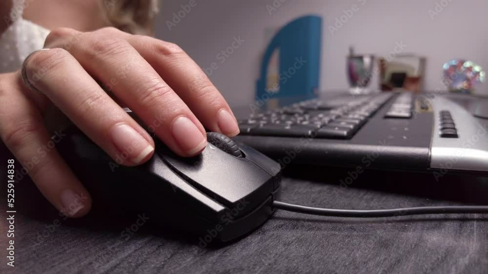 Close up woman hand working with black mouse at the office Close up woman hand working with black mouse at the office
