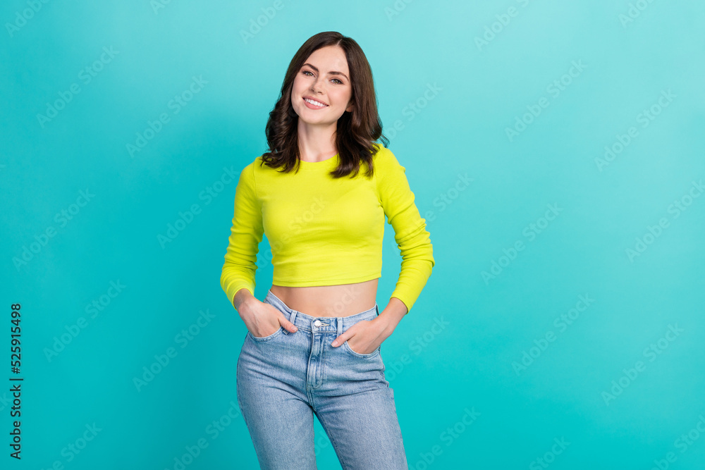 Portrait photo of young attractive pretty girl hold hand pocket denim smiling confident model posing clothes isolated on cyan color background Portrait photo of young attractive pretty girl hold hand pocket denim smiling confident model posing clothes isolated on cyan color background