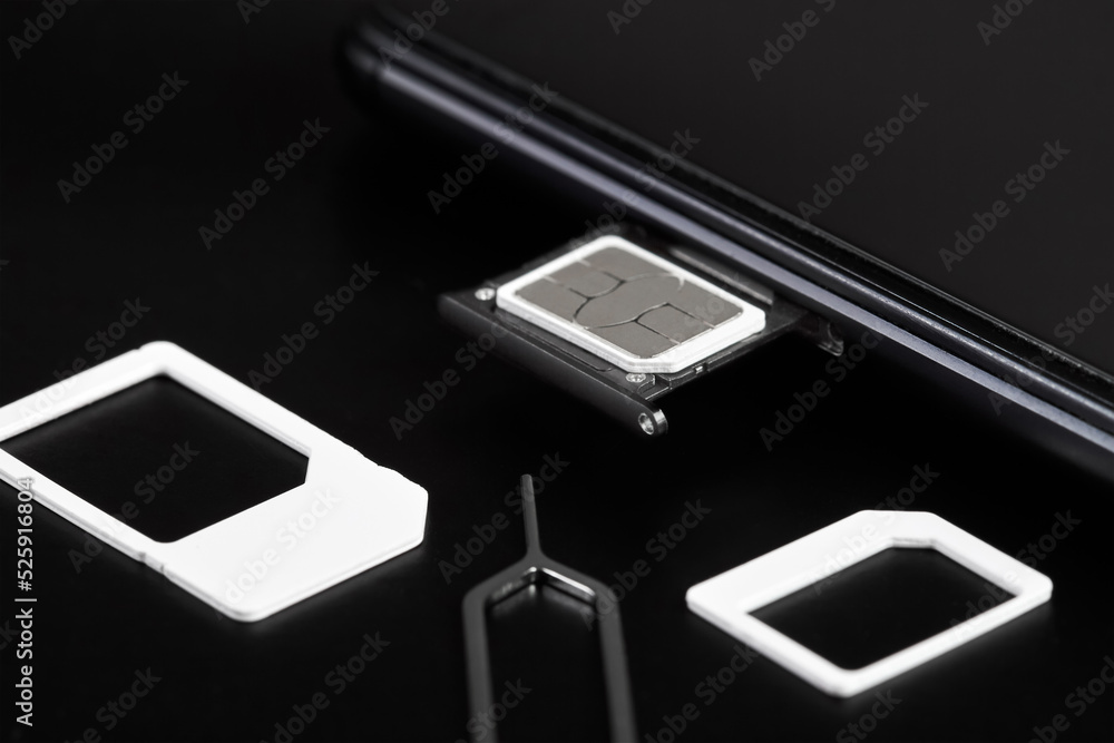 SIM card inserted into the sim card tray of a smartphone with pin needle tray remover SIM card inserted into the sim card tray of a smartphone with pin needle tray remover