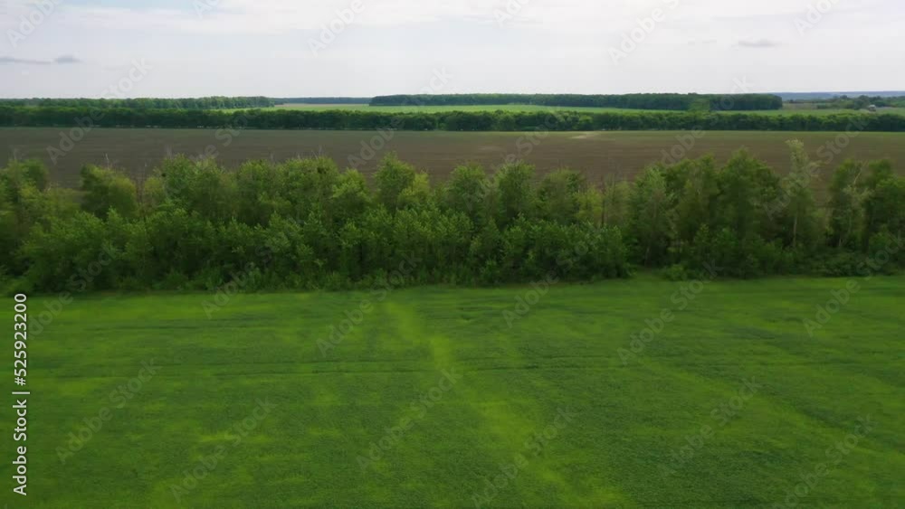2022 - aerial over farm fields, grass and agriculture crops growing in Ukraine suggests Ukranian landscape. 2022 - aerial over farm fields, grass and agriculture crops growing in Ukraine suggests Ukranian landscape.
