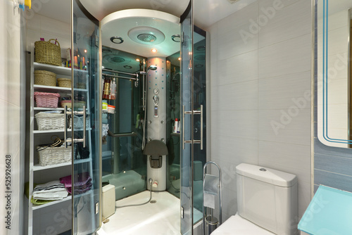 Shower cabin with hydromassage jets, lamps, seat and radio and towel rack