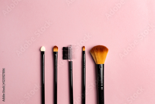 Make up brush on colorful background. Fashion model. Beauty, skincare. Black background. Makeup, cosmetics. Beauty woman face skin care. Colorful background. Makeup product. Eye care.
