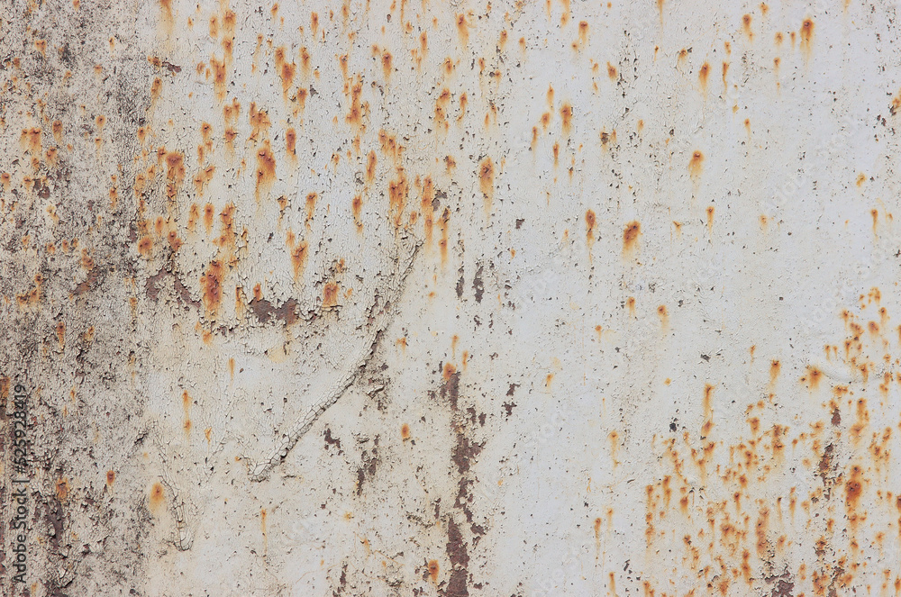 The texture of rusty iron with pieces of old paint.