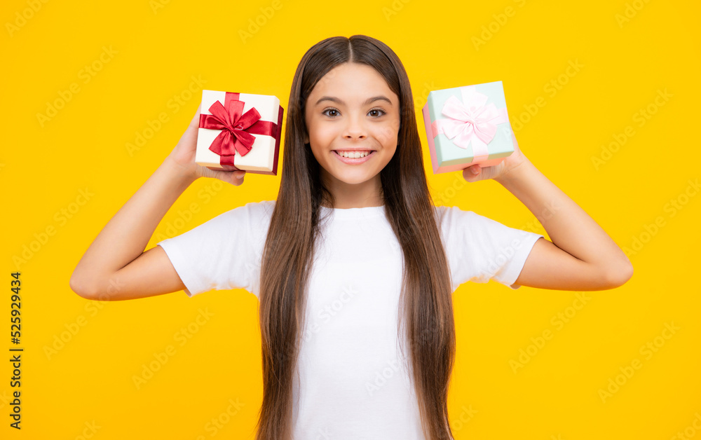 Happy teenager portrait. Child with gift present box on isolated studio background. Gifting for kids birthday. Smiling girl. Happy teenager portrait. Child with gift present box on isolated studio background. Gifting for kids birthday. Smiling girl.