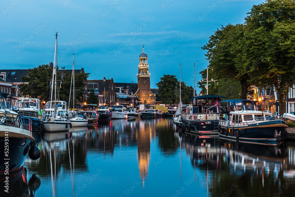 View of the illuminated historical part of the city of Lemmer in Friesland, Netherlands after sunset
