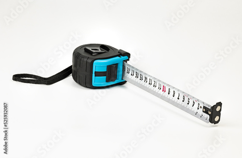 Blue tape measure in a rubberized case, with a bracket for fastening and a loop for storage. photo