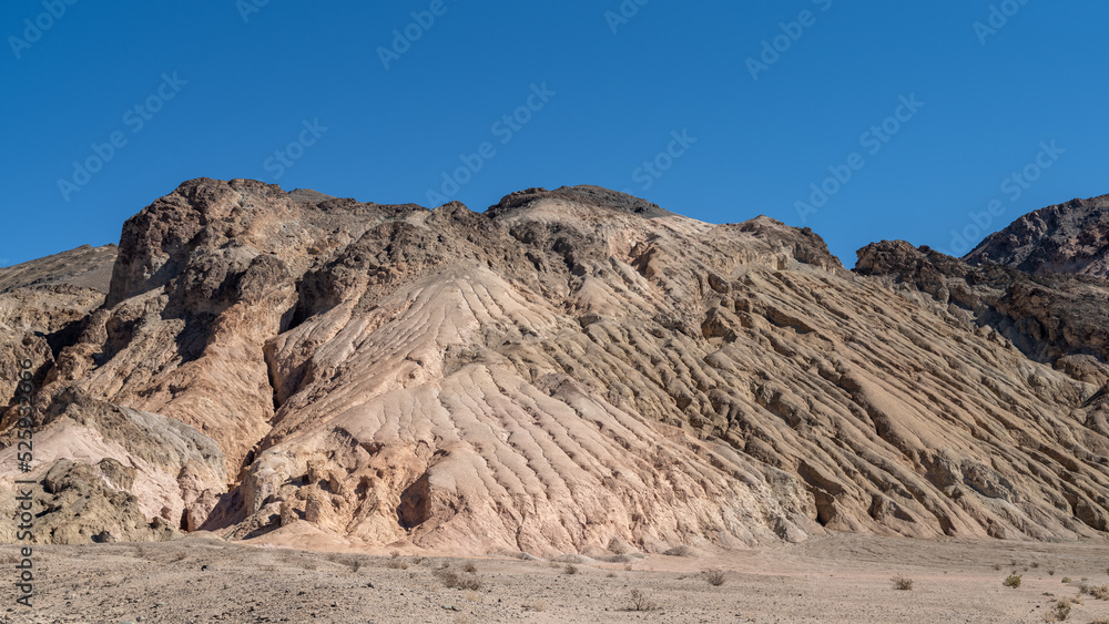Eroded mountain in the Death Valley desert with a blue sky and copy space Eroded mountain in the Death Valley desert with a blue sky and copy space