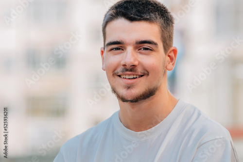 portrait of caucasian young man with beard outdoors