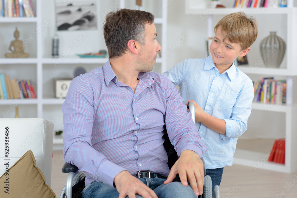 dad in a wheelchair with his son dad in a wheelchair with his son