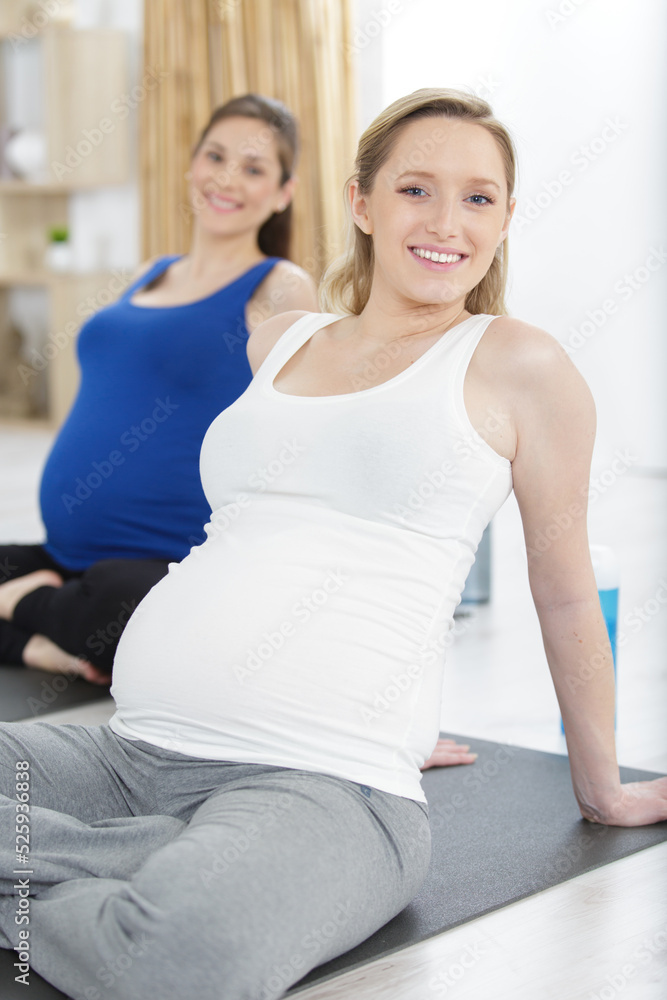 group of pregnant women meditating on yoga class