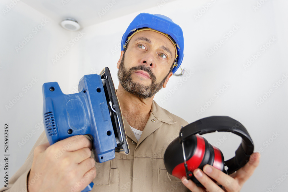 mechanic holding a sander machine mechanic holding a sander machine