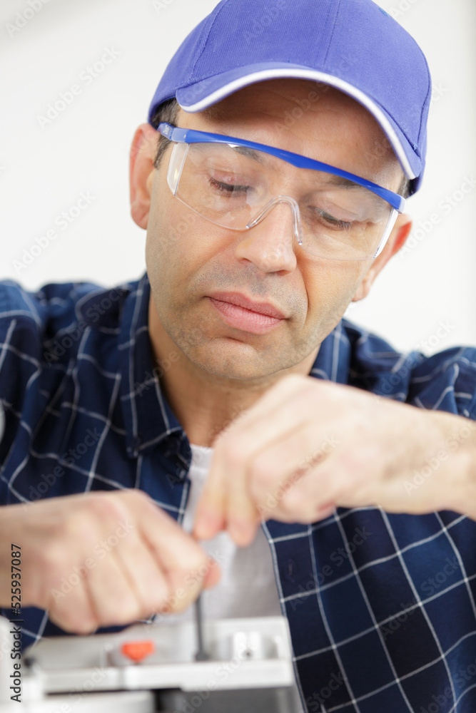 male technician using a screwdriver