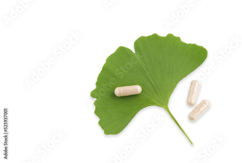 Ginkgo leaf with pills isolated on white for brain, memory protect therapy and treatment of dementia. Ginkgo Biloba composition - natural ingredient for alternative medicine, closeup.