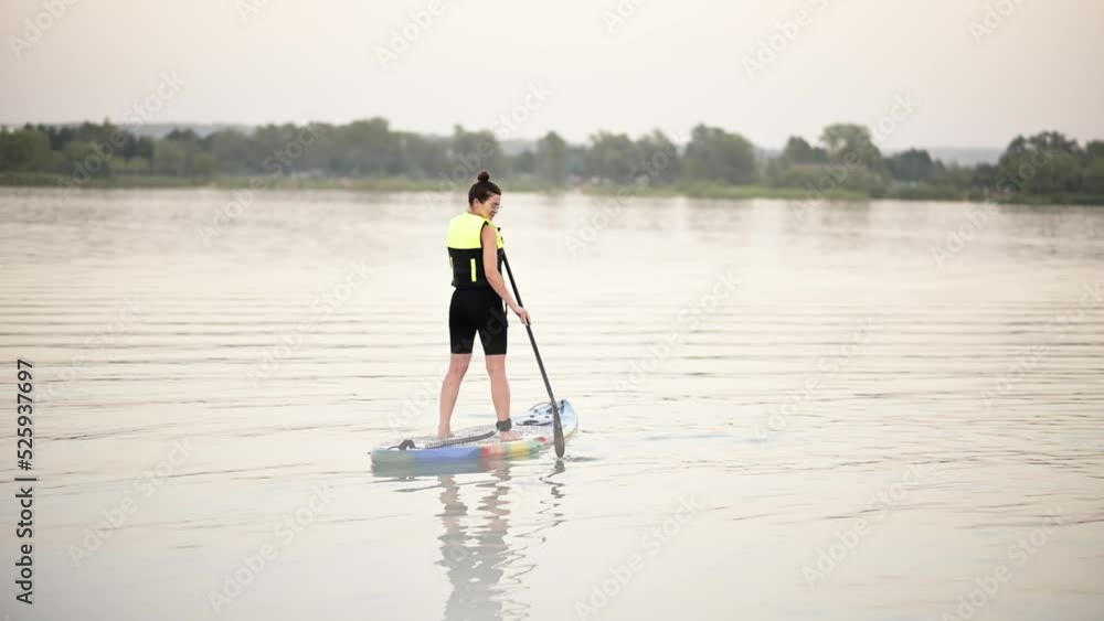 Pretty girl doing paddle in summer
In a life jacket, looks and smiles at the camera on a sap board Pretty girl doing paddle in summer
In a life jacket, looks and smiles at the camera on a sap board