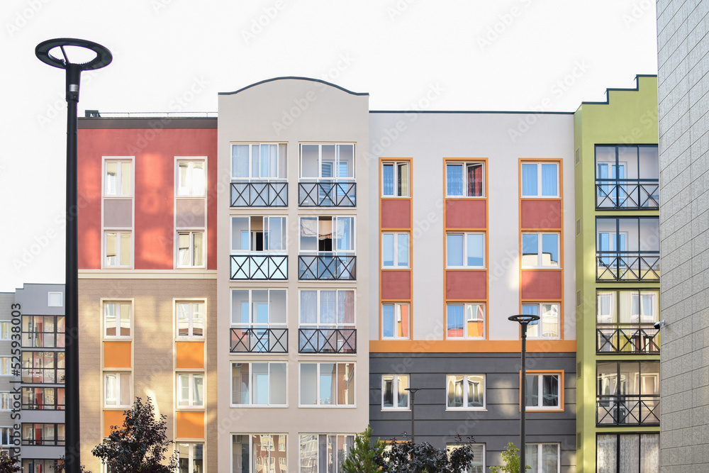 The stylish facade of a residential building with beautiful windows is a new multi-apartment residential quarter of European houses. The stylish facade of a residential building with beautiful windows is a new multi-apartment residential quarter of European houses.