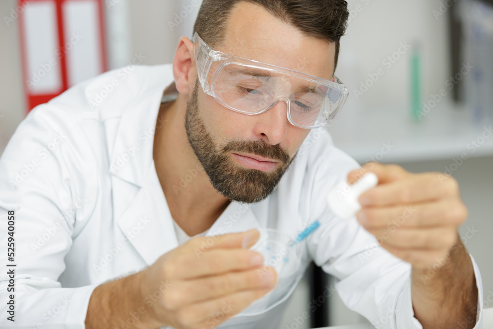 scientist or medical in lab coat holding test tube scientist or medical in lab coat holding test tube