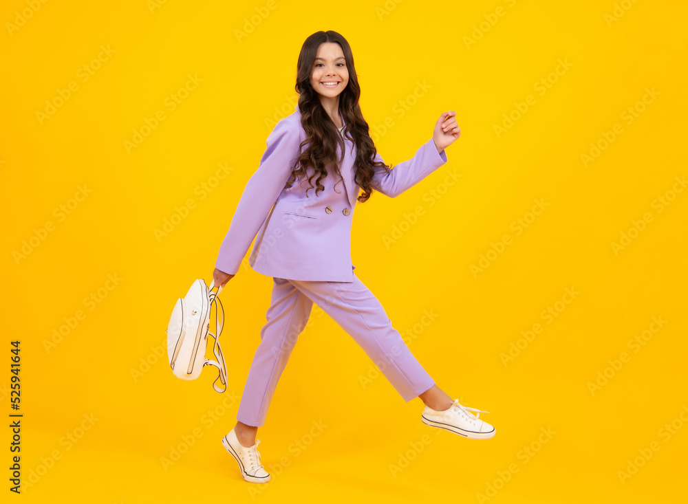 Back to school. Fashion teenage school girl ready to learn. School children on yellow isolated background. Run and jump. Happy face, positive and smiling emotions of teenager girl. Back to school. Fashion teenage school girl ready to learn. School children on yellow isolated background. Run and jump. Happy face, positive and smiling emotions of teenager girl.