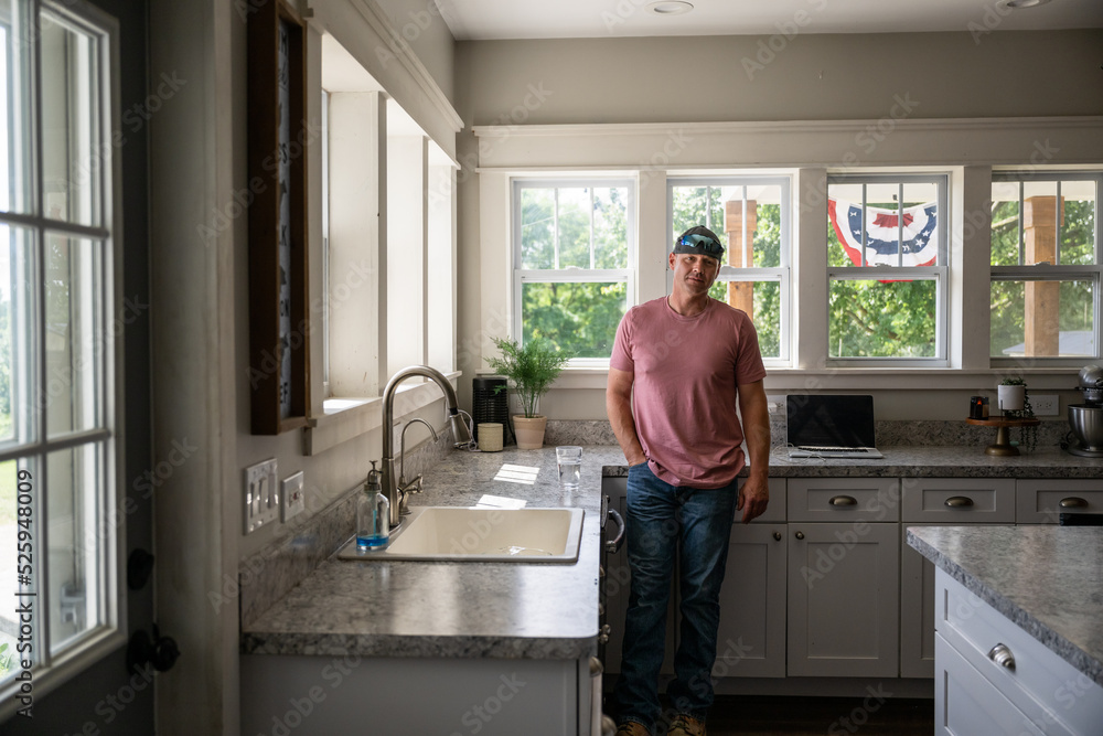 Marine veteran at home with family on a early morning in the kitchen. Marine veteran at home with family on a early morning in the kitchen.