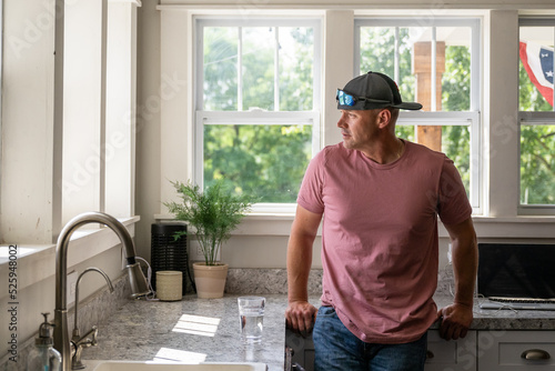 Marine veteran at home with family on a early morning in the kitchen.