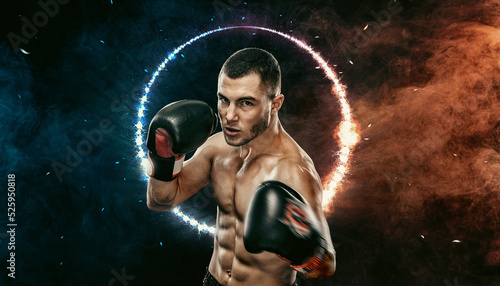 Boxer boxing in the ring. Muay thai sportsman fighting in gloves in cage. Man Isolated on black background with smoke and neon. Copy Space.