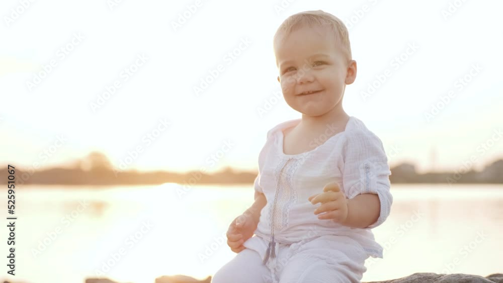 Portrait of happy kid playing with his mom on the lake on sunset Portrait of happy kid playing with his mom on the lake on sunset