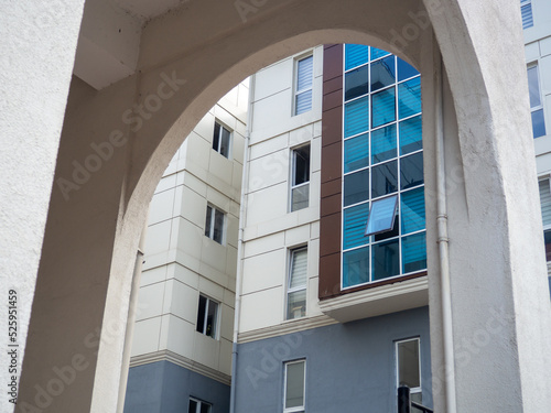 Arch and glazed windows. Modern urban architecture. High building from an unusual angle