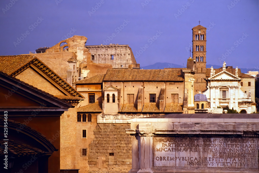Telephoto view of several buildings in the area of the Roman forum. with parts of the Arch of Septimius Severus, the Church of Santa Francesca Romana and the Colosseum visible