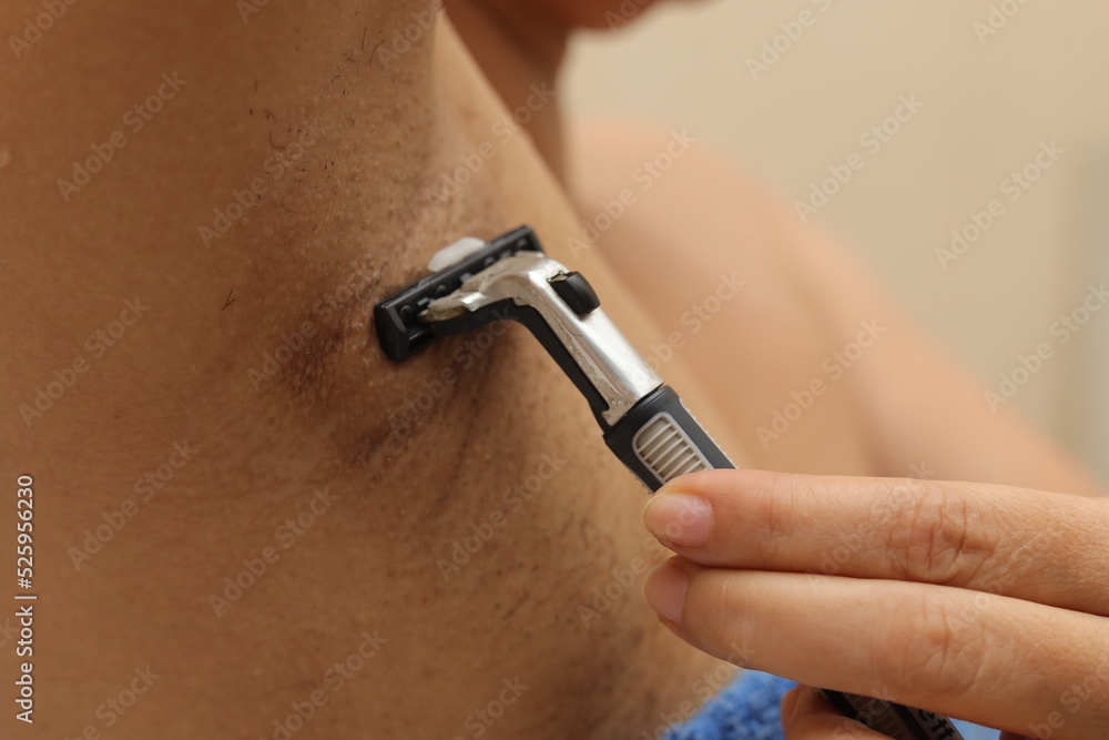 Female unshaved armpits or woman with long hair underarm, depilation, hair removal concept. Young woman shaves hairy armpits with a disposable razor. Close-up, selective focus. Female unshaved armpits or woman with long hair underarm, depilation, hair removal concept. Young woman shaves hairy armpits with a disposable razor. Close-up, selective focus.