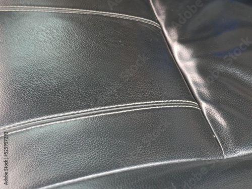 closeup of black leather car seat.