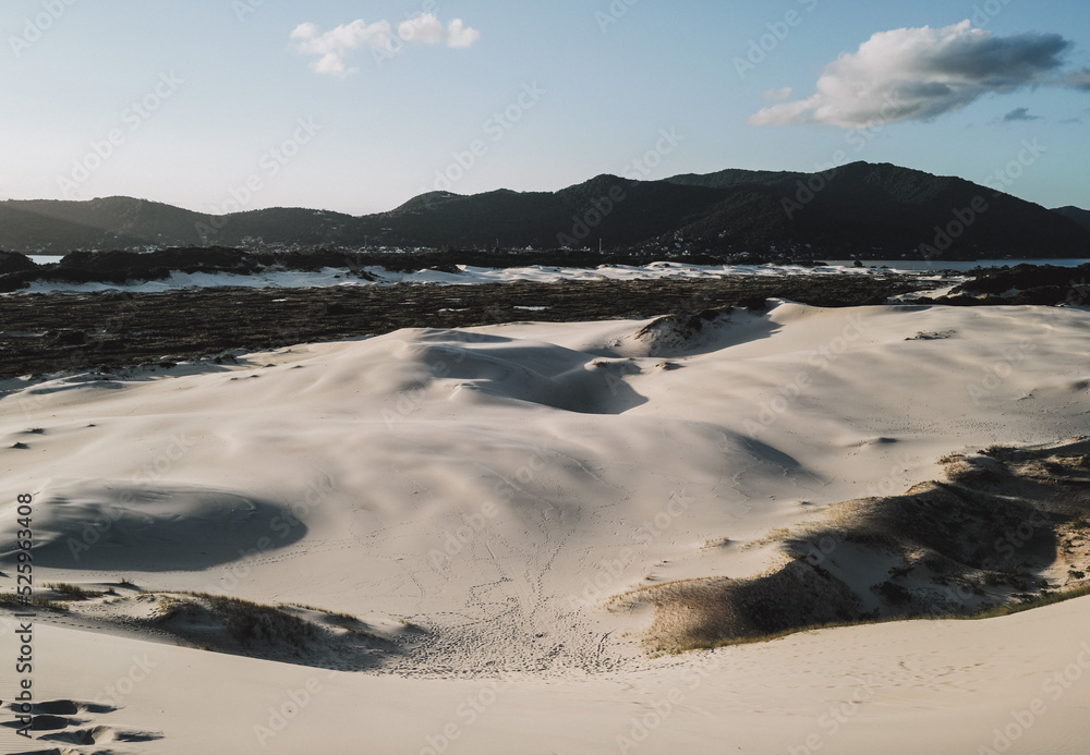 Sand dunes near the ocean with san d board in Brazil, Florianopolis Sand dunes near the ocean with san d board in Brazil, Florianopolis