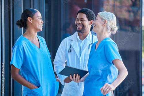 Diversity, teamwork and healthcare, a team of doctors talking and laughing outside a hospital. A happy black doctor and women nurses having a conversation. A group of medical employees during a break
