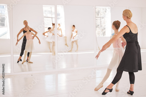 Ballet, student and teacher in dance studio training and motivation support looking in mirror at girl dancer. Creative, school and dancing center with kids learning elegant and artistic