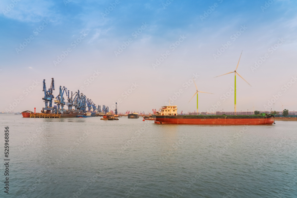 Yangtze River port wharf and wind turbine and sunset scenery in Jiangyin City, China