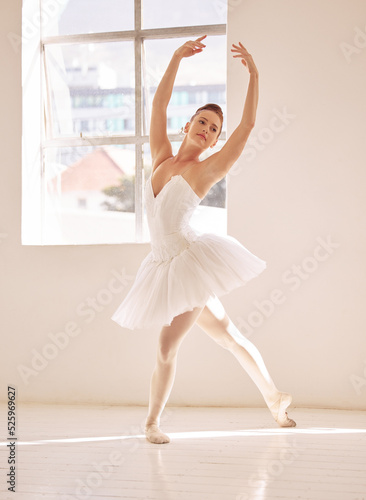 Dance, ballet and studio with a woman dancer training, practicing or dancing for a performance, recital or rehearsal. Artistic, perform or technique with a young female in a school for production art