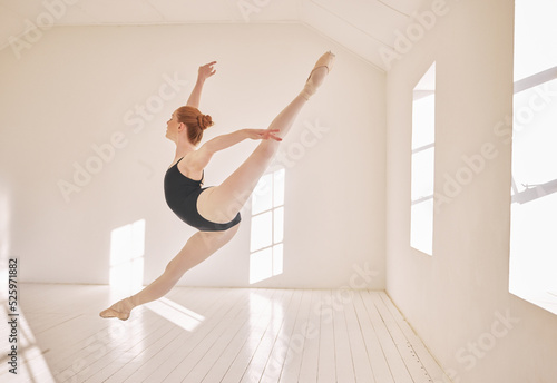 Ballet, jump and performance dance studio with young student. Dancer girl with energy in isolated classroom and moving in the air. Beautiful woman ballerina with strong body and stunning posture.