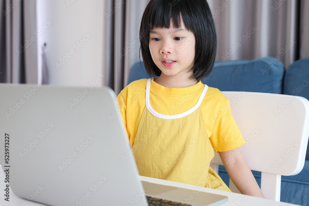 little asian girl student study online using laptop computer at home little asian girl student study online using laptop computer at home