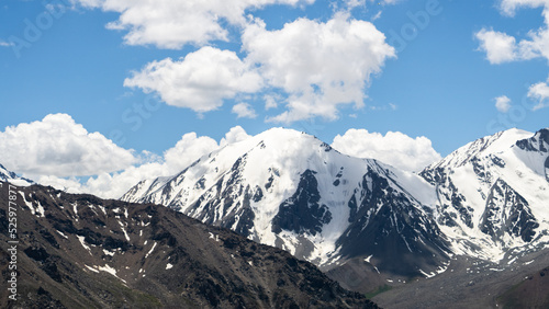 snowy mountain peaks in the clouds. mountain gorge. glaciers on mountain tops