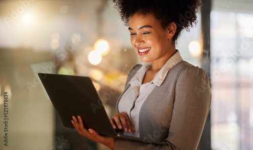 Photos Business woman doing research on the internet with a laptop in a corporate modern office