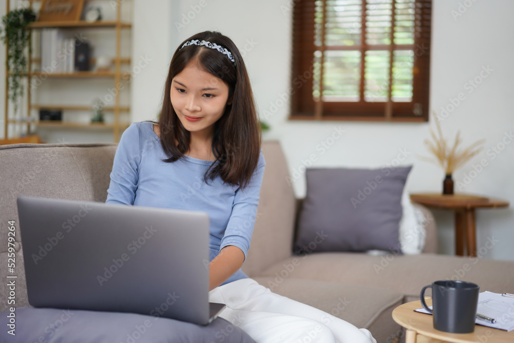 Work from home concept, Business women is typing financial report while working remotely at home Work from home concept, Business women is typing financial report while working remotely at home