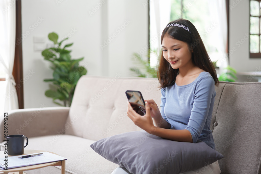 Work from home concept, Business women use smartphone to search data while working remotely at home Work from home concept, Business women use smartphone to search data while working remotely at home