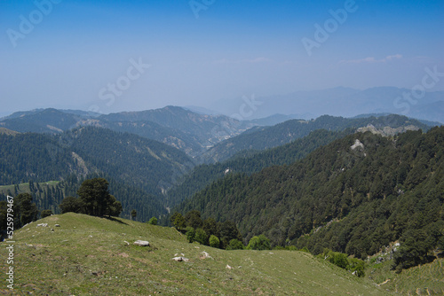 Beautiful scenery of mountain valley, grassland and blue sky.