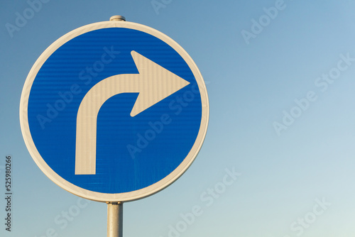 Road sign blue right turn signal on sky background