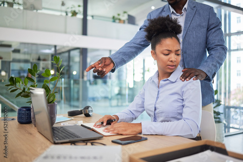Workplace harassment, sexual abuse and unprofessional behavior from manager and business man touching a coworker in an office. Woman feeling uncomfortable, scared and worried about unwanted advances photo