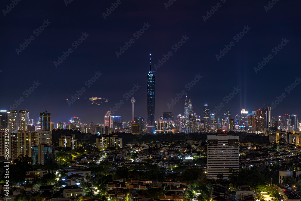 Kuala Lumpur city skyline with Genting Highland behind the view.