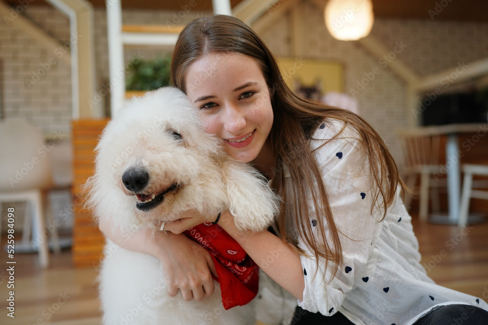 Young woman with her dog at modern house on nature light. Young woman with her dog at modern house on nature light.