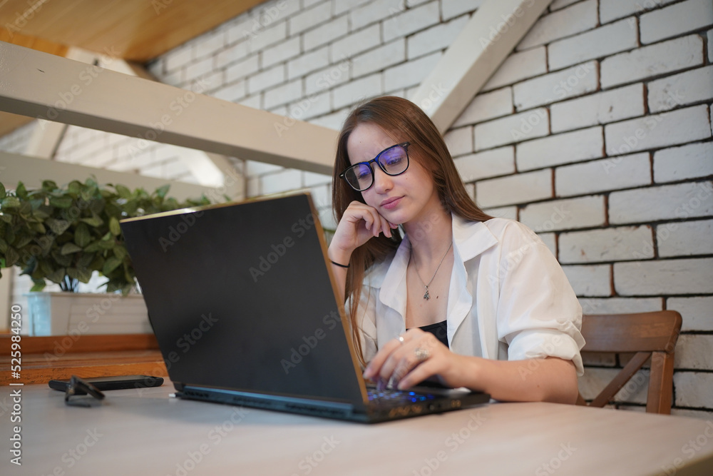 Technology and people concept, young woman using laptop and internet technology and sitting on the desk with laptop computer. Technology and people concept, young woman using laptop and internet technology and sitting on the desk with laptop computer.